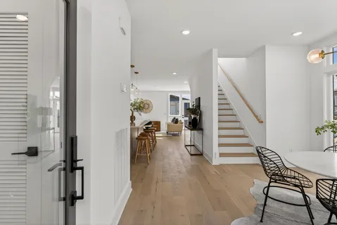 a view of a room with lots of wooden furniture and entryway