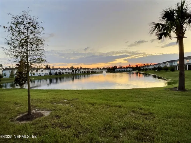 a view of a lake with houses in the back