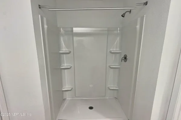 a bathroom with a glass shower door