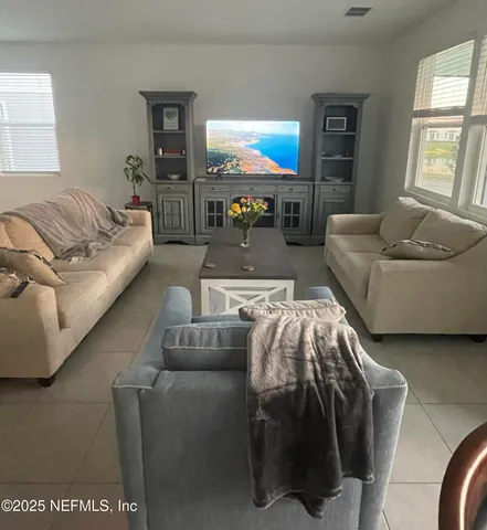 a living room with furniture and a large window