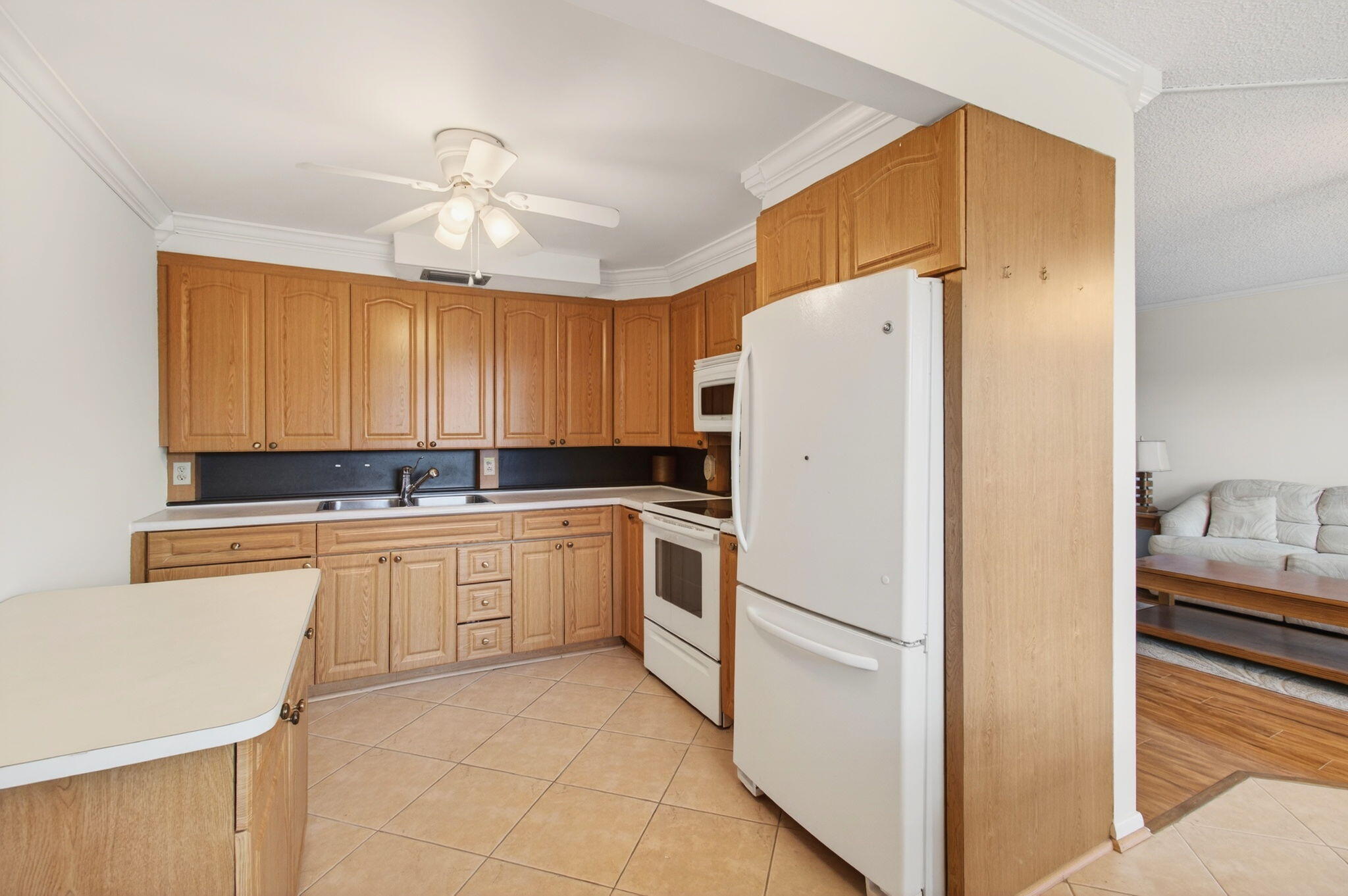 3007 Yarmouth C Boca Raton, FL 33434 - Photo 11 of 70 a white refrigerator freezer sitting inside of a kitchen