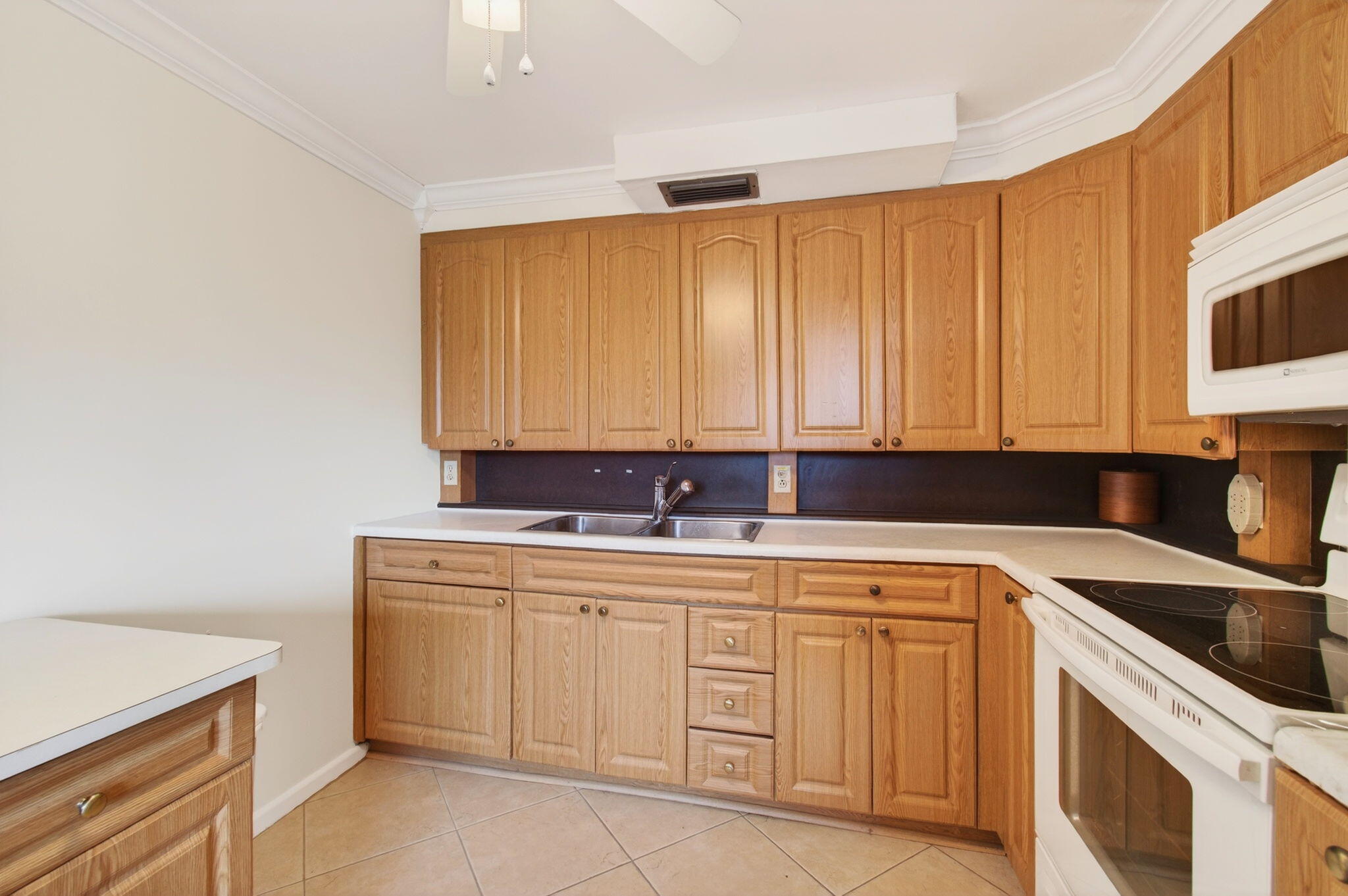 3007 Yarmouth C Boca Raton, FL 33434 - Photo 12 of 70 a kitchen with a sink cabinets and washing machine