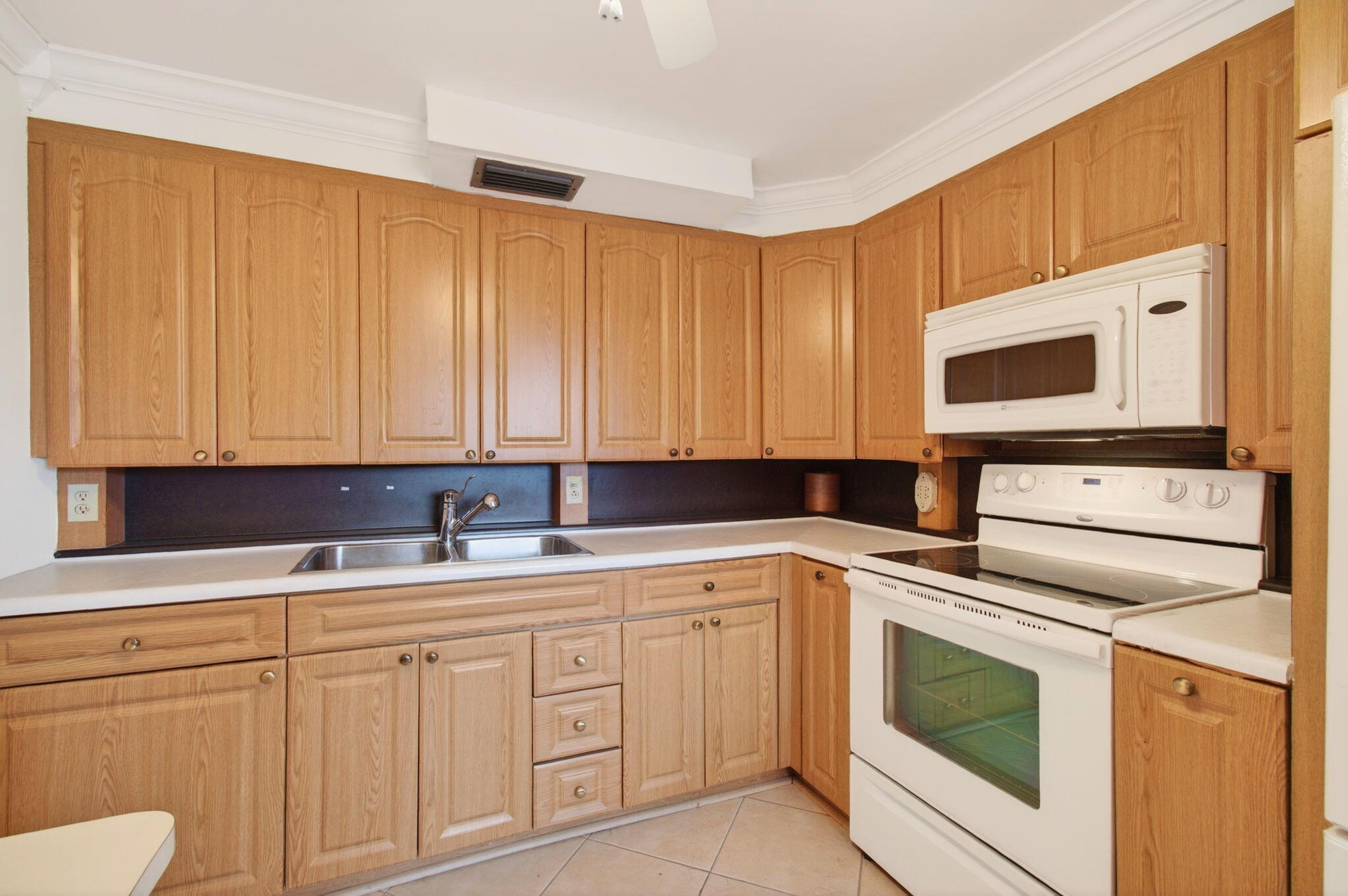 3007 Yarmouth C Boca Raton, FL 33434 - Photo 13 of 70 a kitchen with cabinets appliances a sink and a microwave