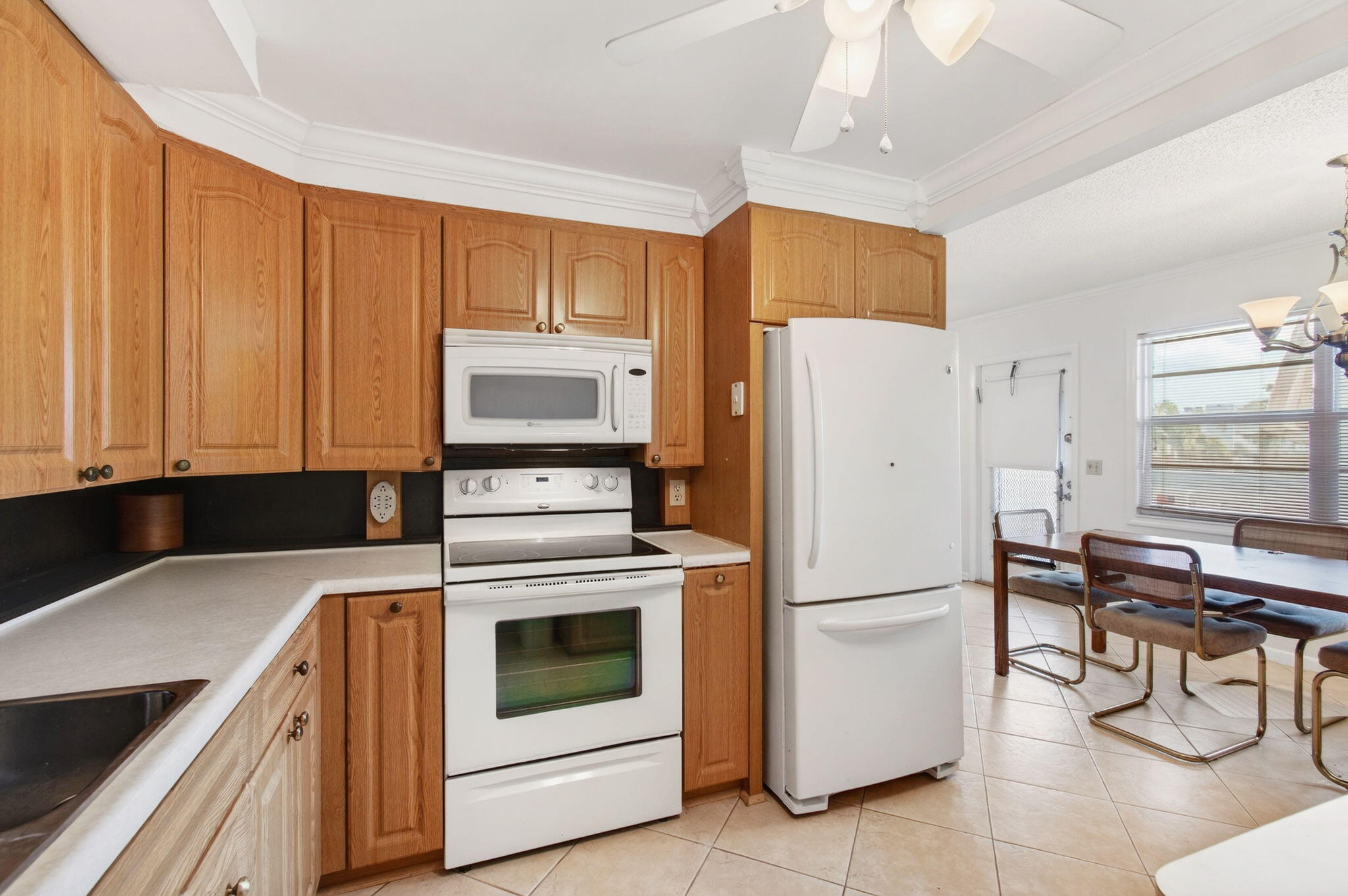 3007 Yarmouth C Boca Raton, FL 33434 - Photo 14 of 70 a kitchen with a white stove top oven and refrigerator