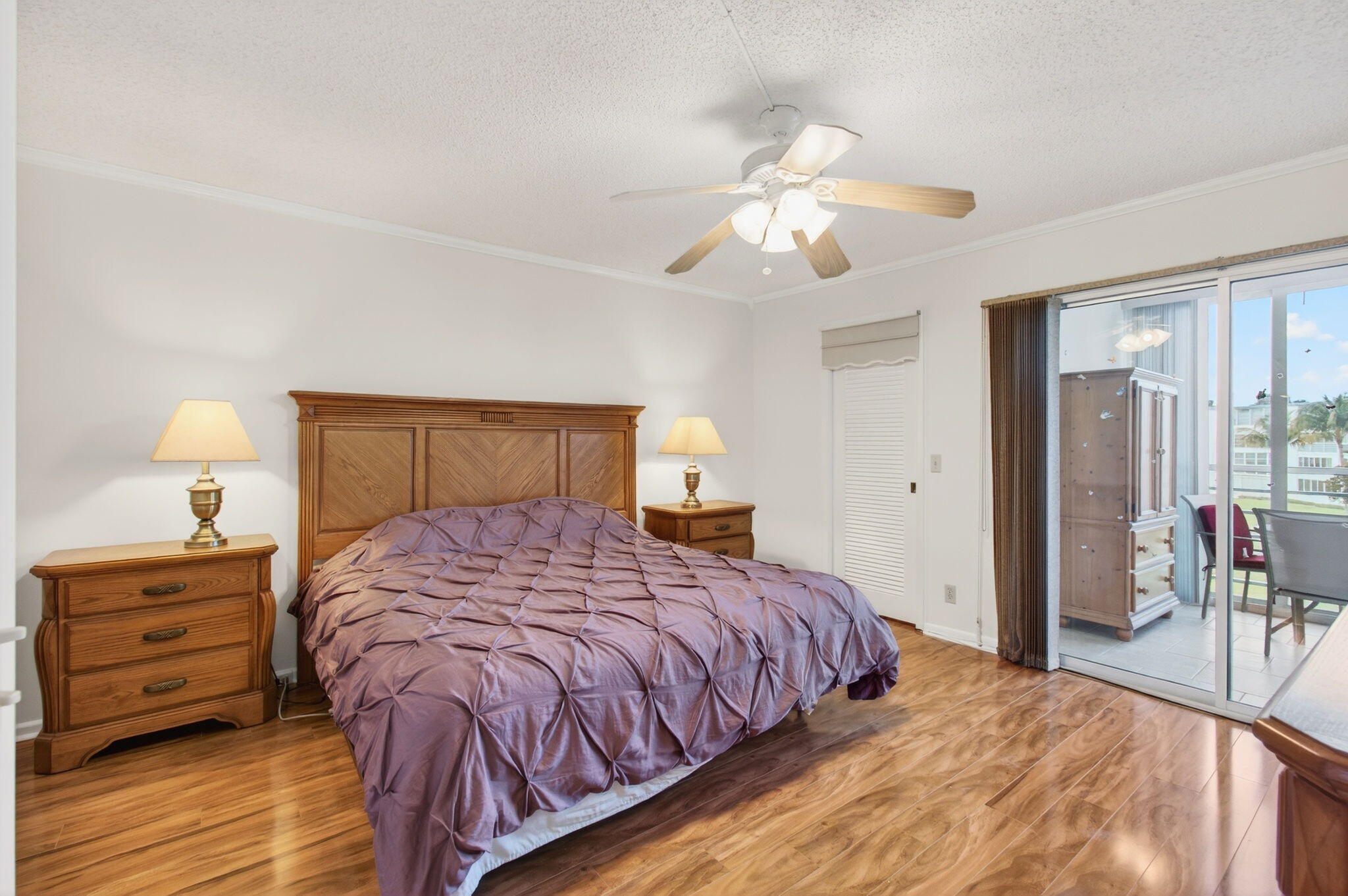 3007 Yarmouth C Boca Raton, FL 33434 - Photo 19 of 70 a bedroom with a bed and a chandelier