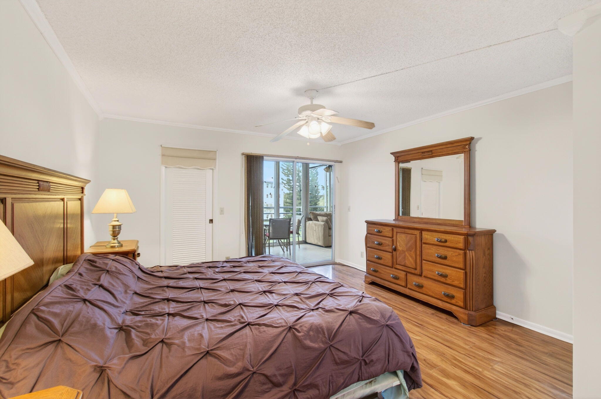 3007 Yarmouth C Boca Raton, FL 33434 - Photo 20 of 70 a bedroom with a bed and a dresser