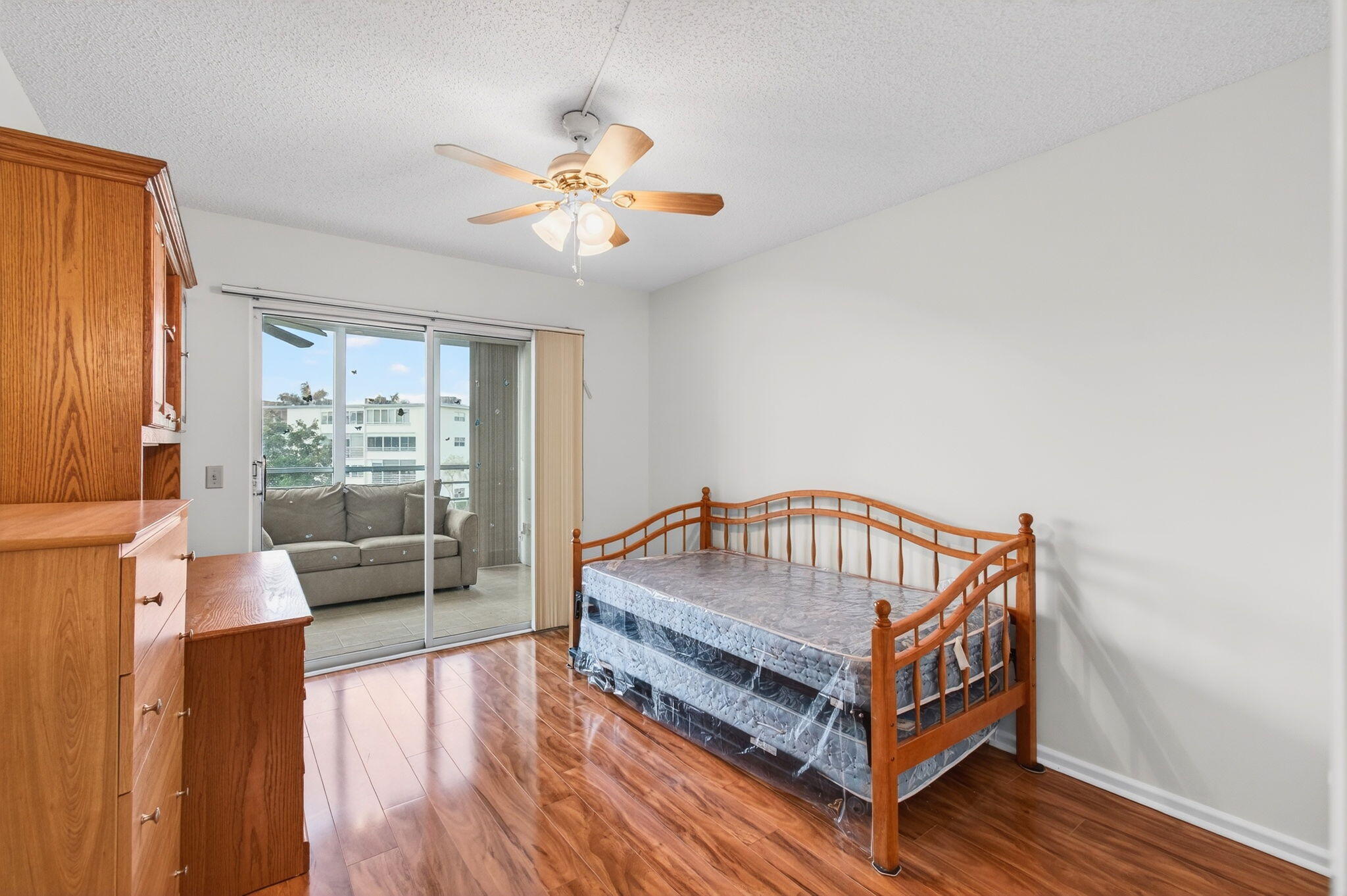 3007 Yarmouth C Boca Raton, FL 33434 - Photo 24 of 70 a living room with furniture a table and wooden floor