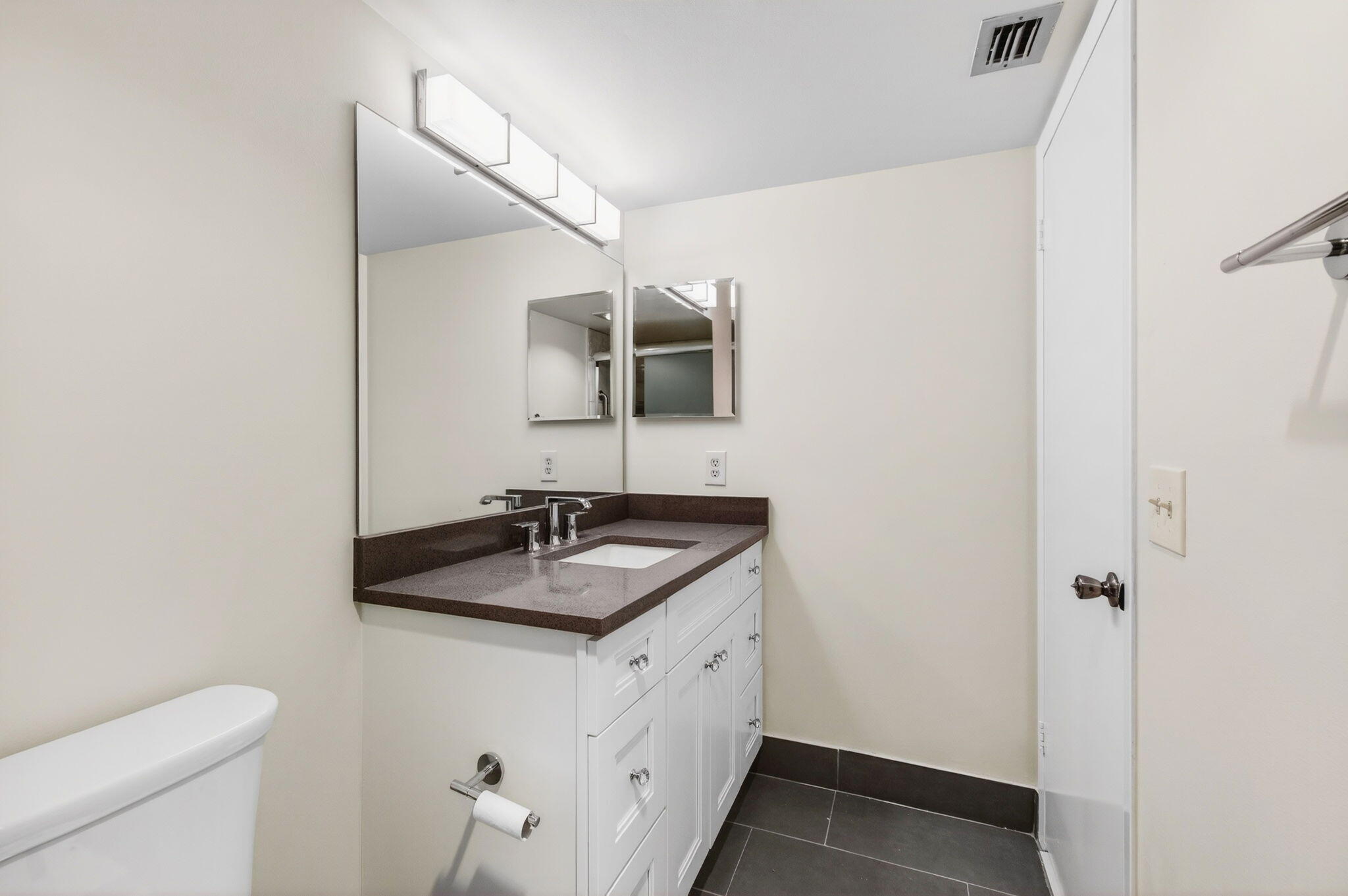 3007 Yarmouth C Boca Raton, FL 33434 - Photo 31 of 70 a bathroom with a granite countertop sink and a mirror