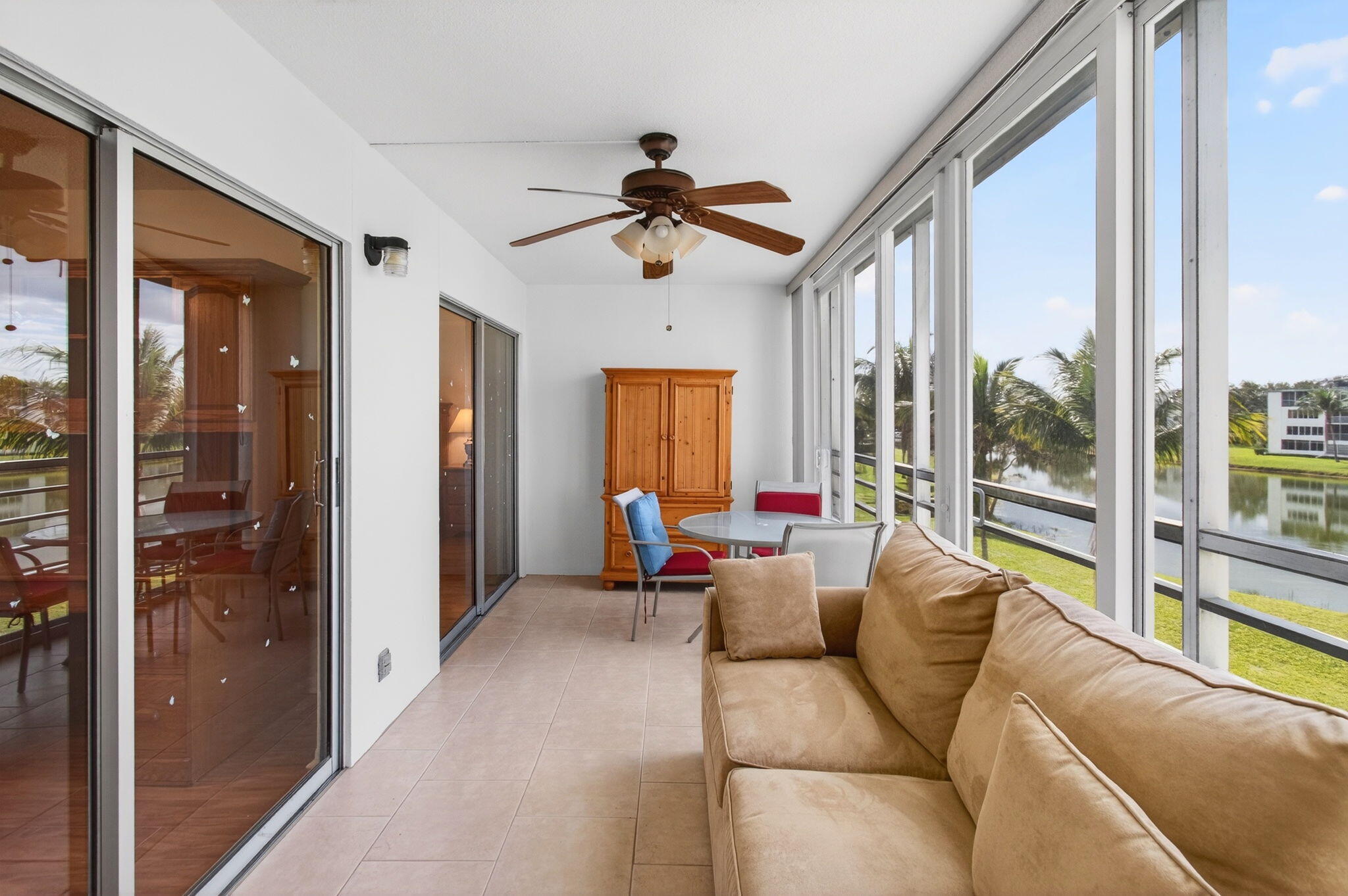 3007 Yarmouth C Boca Raton, FL 33434 - Photo 33 of 70 a living room with furniture ceiling fan and a large window