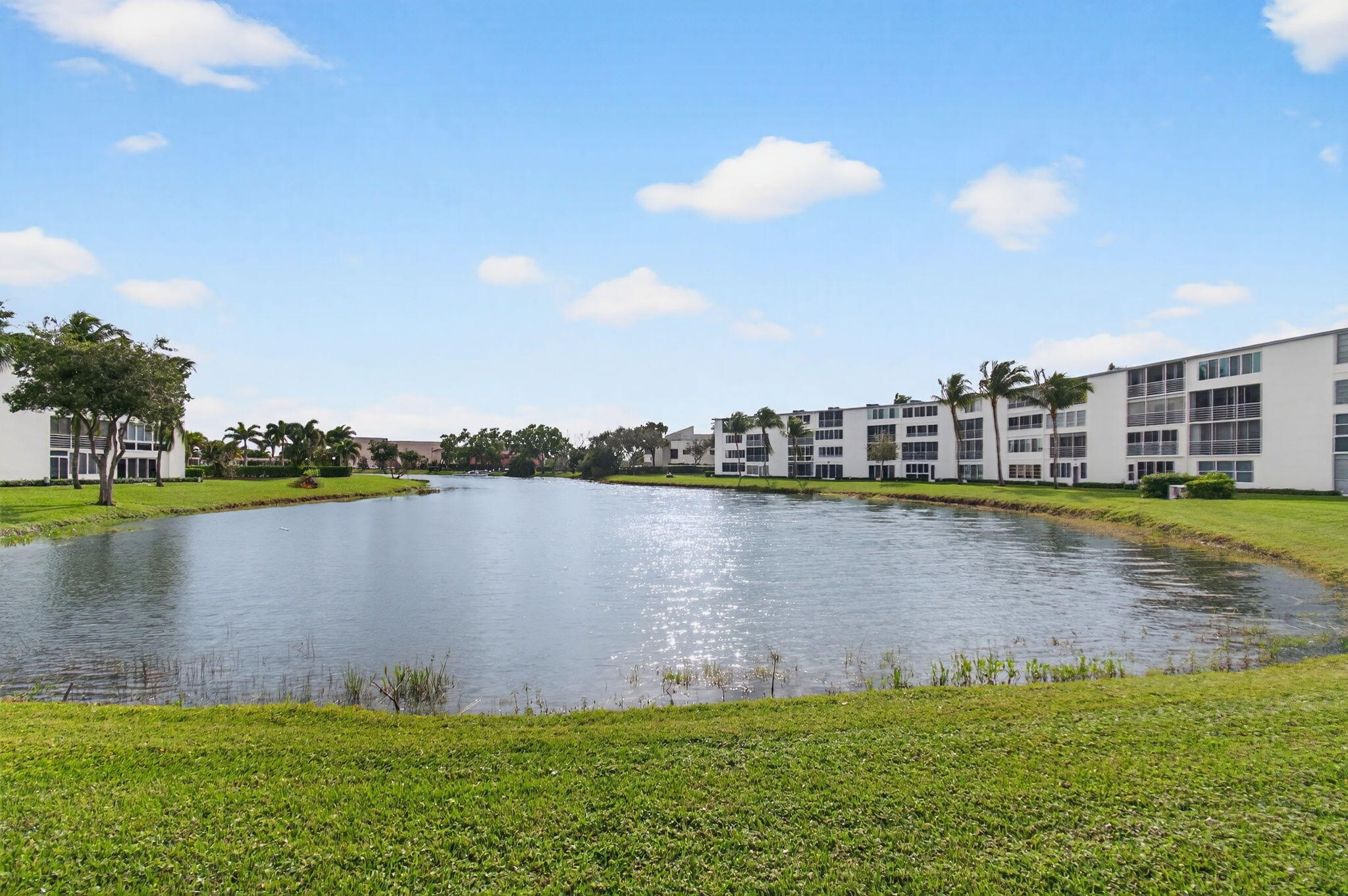 3007 Yarmouth C Boca Raton, FL 33434 - Photo 40 of 70 a view of a lake with a yard