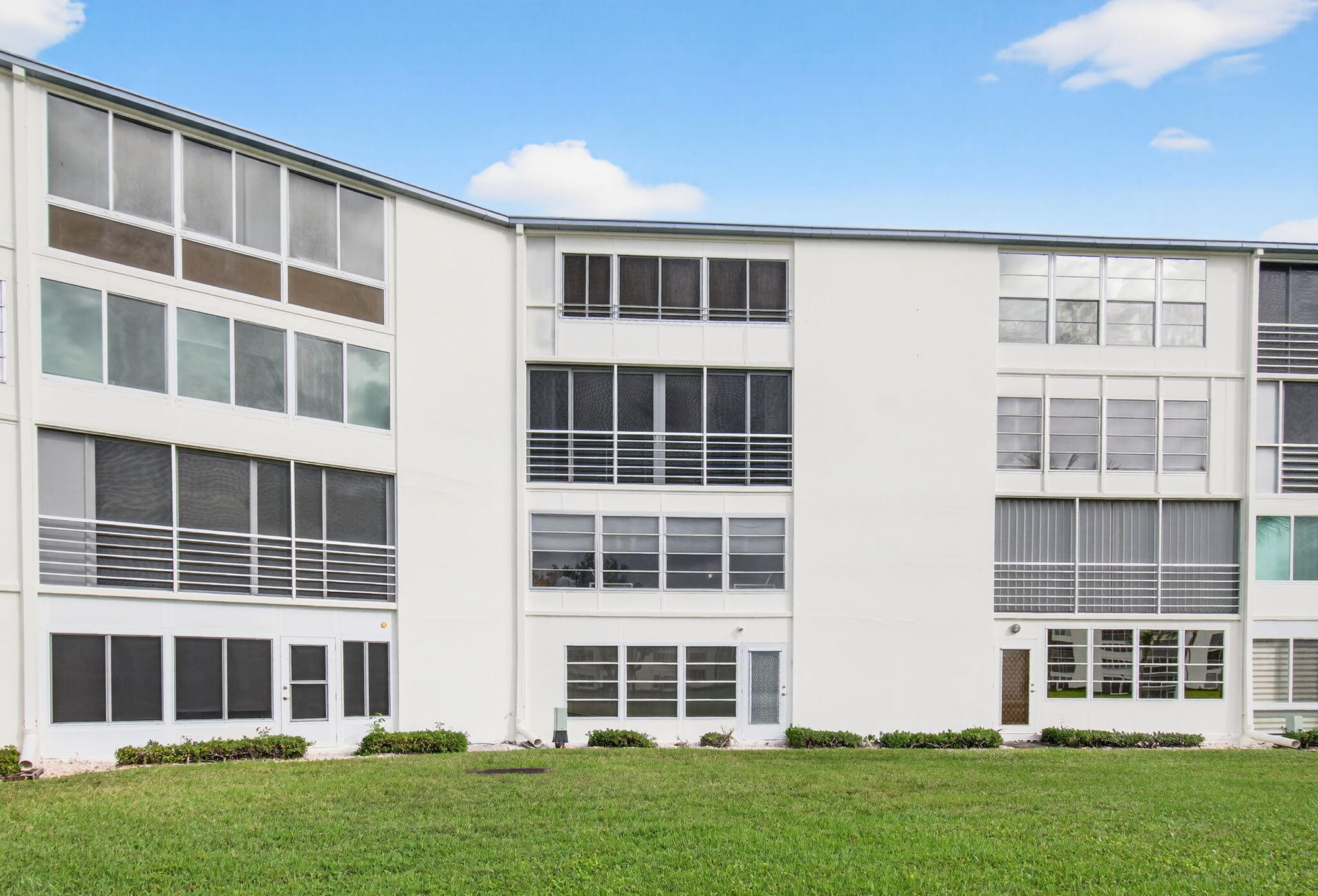 3007 Yarmouth C Boca Raton, FL 33434 - Photo 42 of 70 a front view of a building with a yard