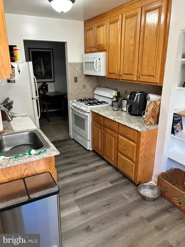 a kitchen with stainless steel appliances granite countertop a stove and a sink