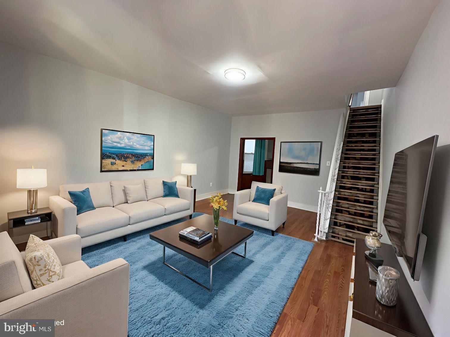 a living room with furniture a rug and a flat screen tv