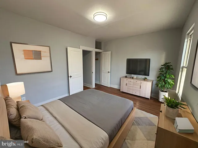 a bedroom with a bed and a television