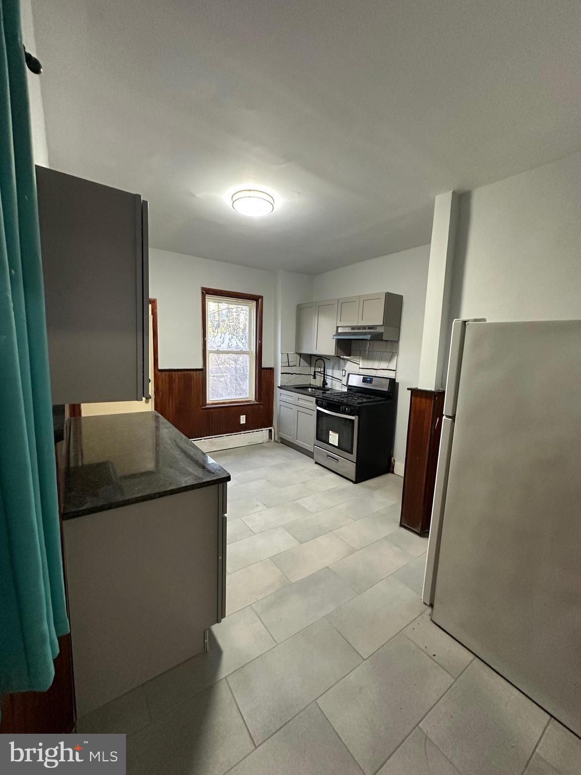 1922 Ruan Street Philadelphia, PA 19124 - Photo 6 of 11 a kitchen with stainless steel appliances granite countertop a refrigerator a stove a sink a microwave and a refrigerator