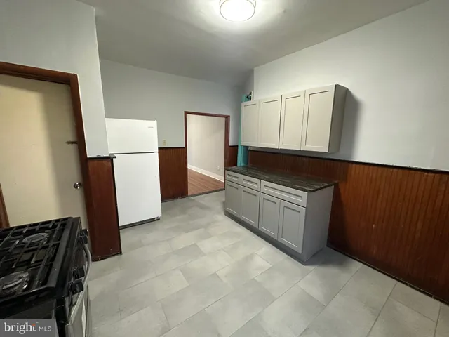 a kitchen with a refrigerator and a stove