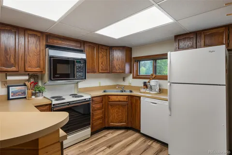 a kitchen with a refrigerator stove and microwave