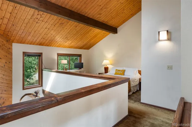 a bed sitting in a bedroom next to a window