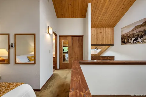 a hallway with a view of living room