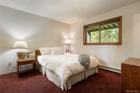 a bedroom with a bed lamp and window