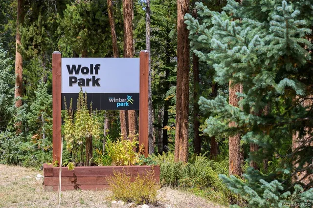 an sign that is sitting in front of flowers