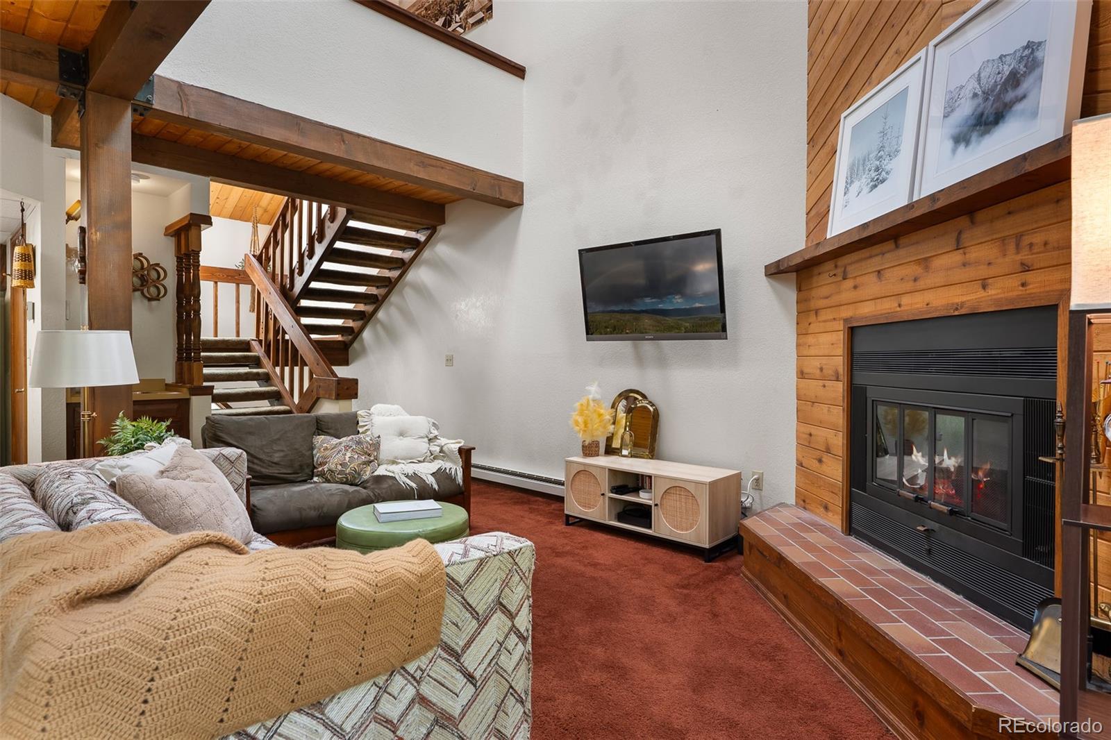 300 Kings Crossing Road, Unit B3 Winter Park, CO 80482 - Photo 9 of 38 a living room with furniture a flat screen tv and a fireplace