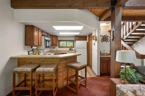 a view of a dining room with furniture and a chandelier
