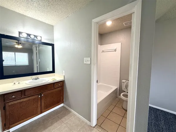 a bathroom with a bathtub and a double vanity sink
