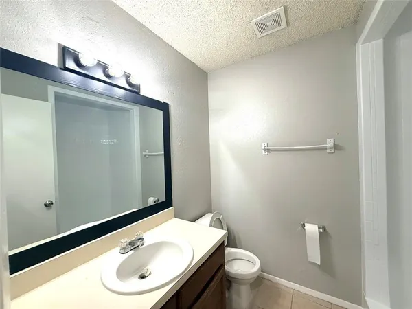 a bathroom with a sink a toilet and mirror