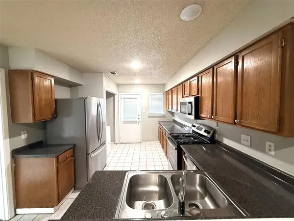 a kitchen with a refrigerator and a sink