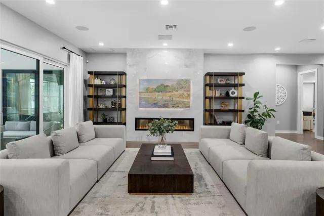 a kitchen with stainless steel appliances kitchen island granite countertop a stove a sink a oven a dining table and chairs