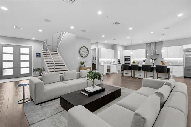 a large kitchen with kitchen island a large counter top appliances and cabinets