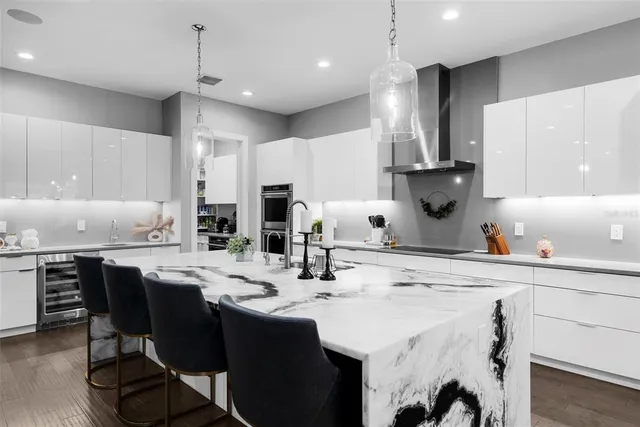 a bathroom with a granite countertop toilet a sink and a mirror