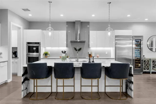 a spacious bedroom with a bed a couch and a large window