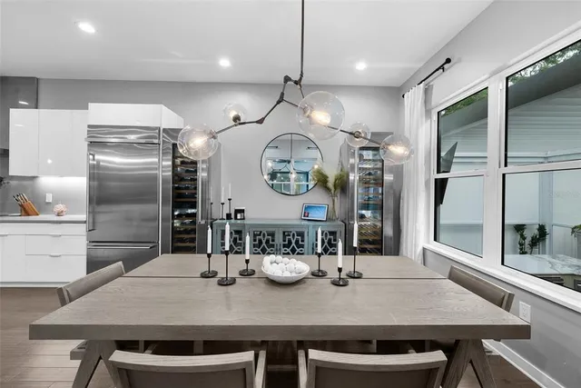 a living room with patio furniture and a floor to ceiling window