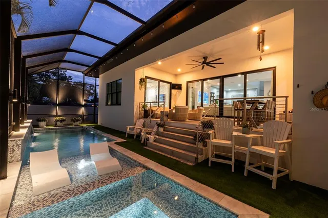 a view of a house with a yard and sitting area