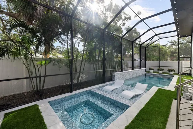a view of a house with a yard and potted plants