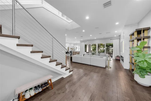 a living room with furniture potted plant and a large window