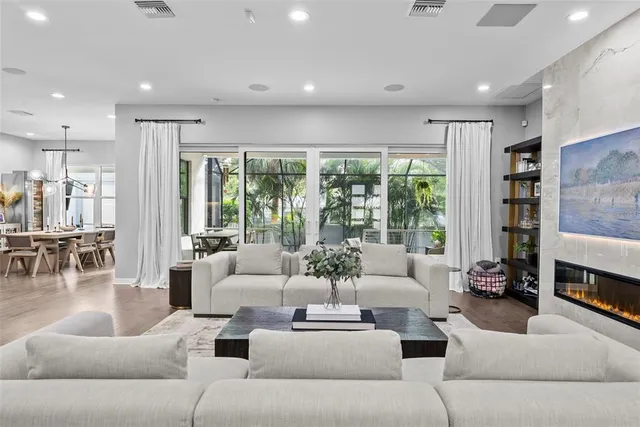 a kitchen with kitchen island granite countertop a sink cabinets and wooden floor