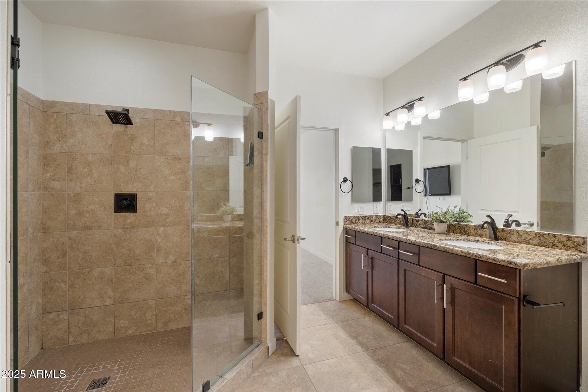 2511 West Queen Creek Road, Unit 230 Chandler, AZ 85248 - Photo 9 of 37 a bathroom with a double vanity sink mirror and shower