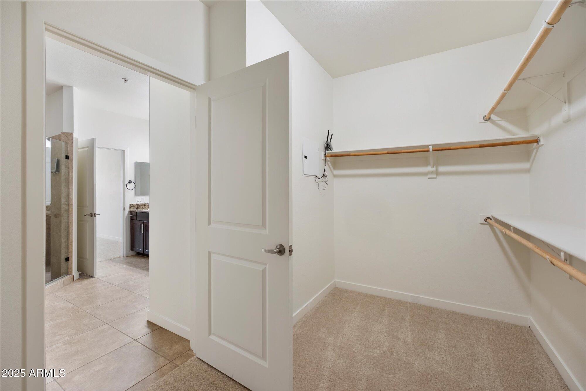 2511 West Queen Creek Road, Unit 230 Chandler, AZ 85248 - Photo 11 of 37 a view of a hallway with wooden shelves