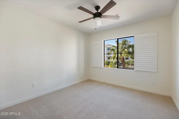 a bedroom with a bed a table and chair