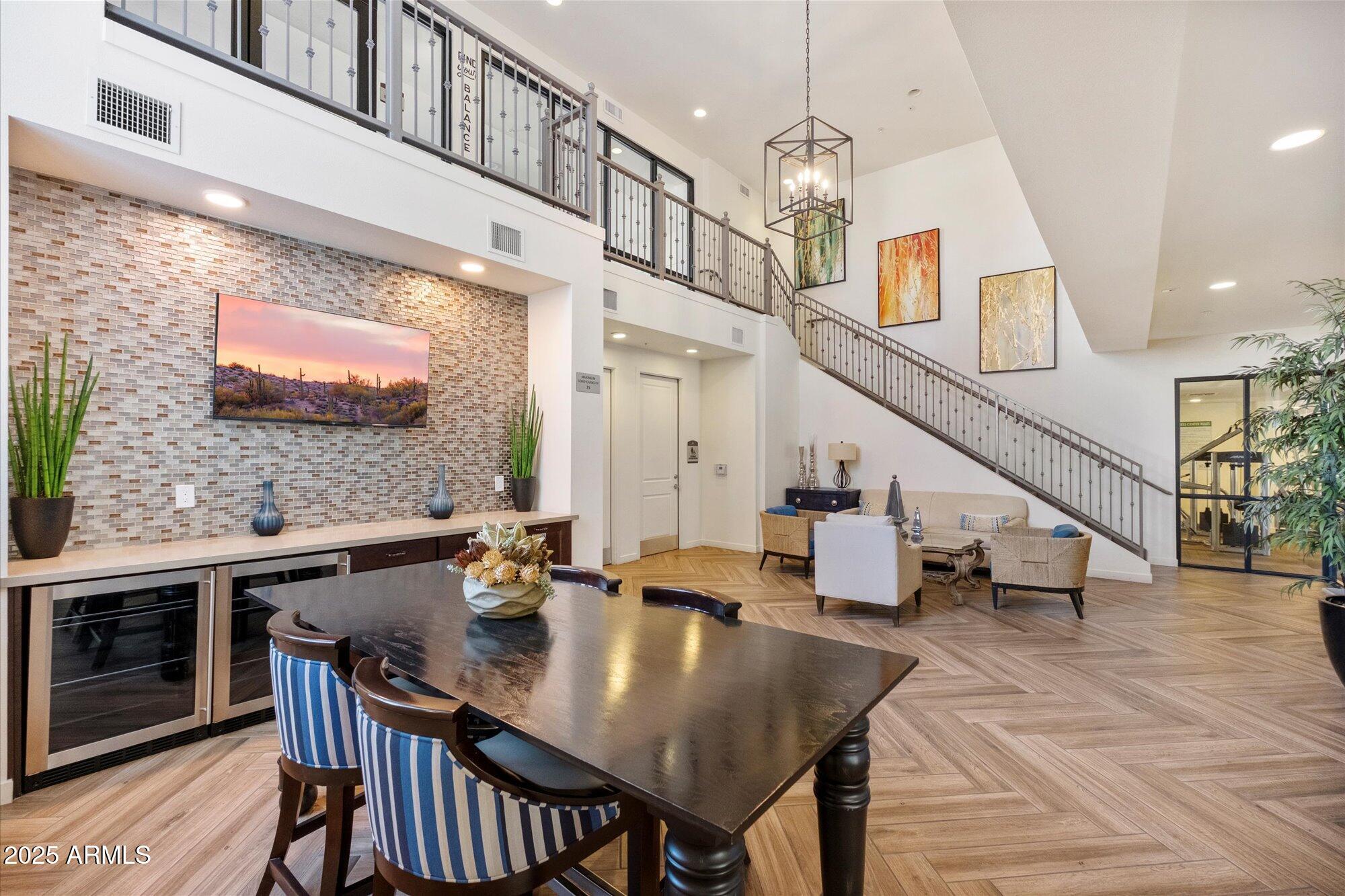 2511 West Queen Creek Road, Unit 230 Chandler, AZ 85248 - Photo 21 of 37 a view of a dining room with furniture and wooden floor