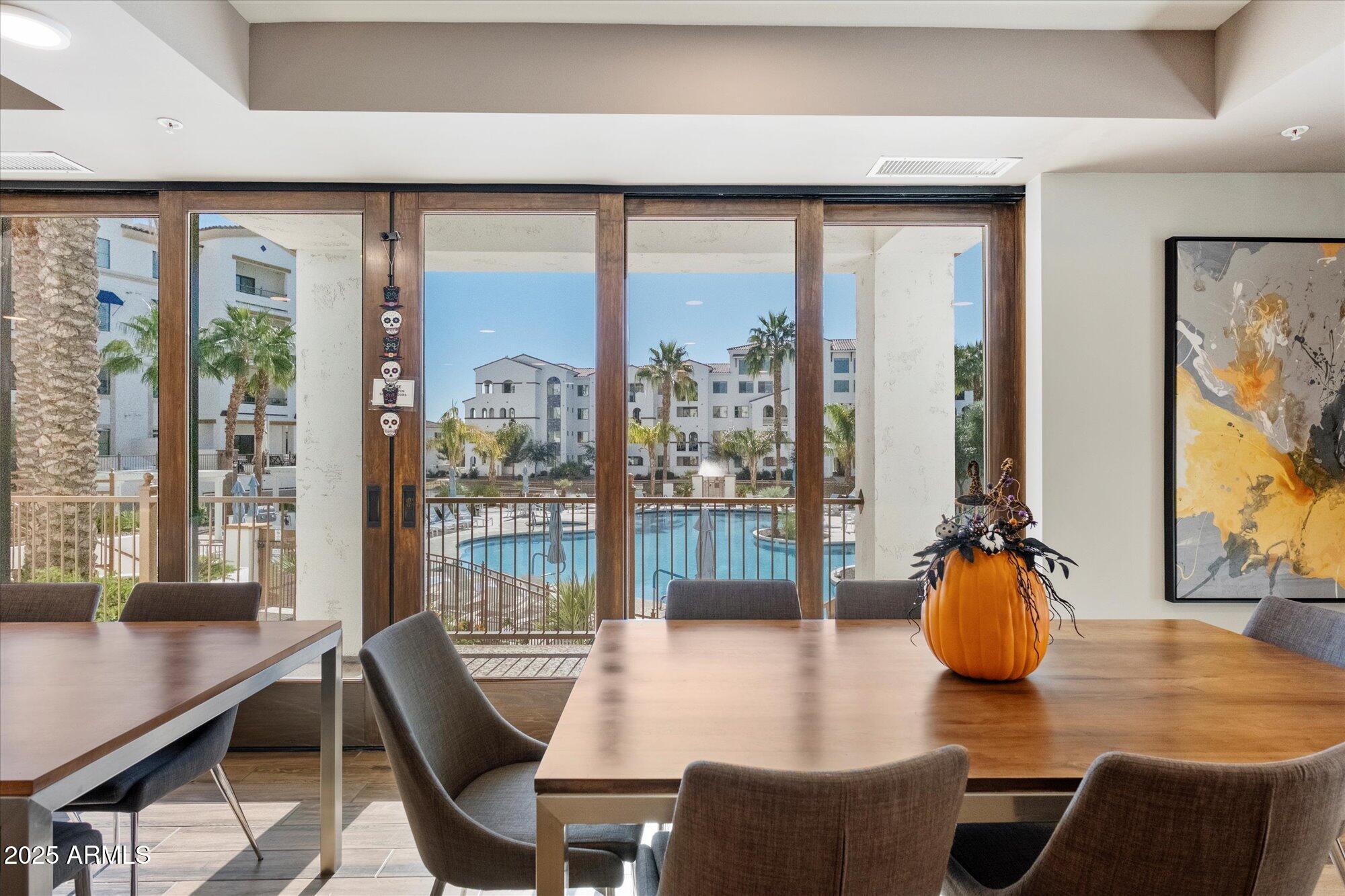 2511 West Queen Creek Road, Unit 230 Chandler, AZ 85248 - Photo 22 of 37 a dining room with furniture and wooden floor