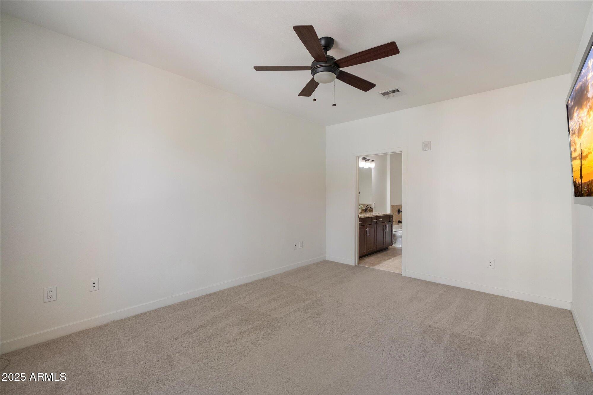 2511 West Queen Creek Road, Unit 230 Chandler, AZ 85248 - Photo 7 of 37 an empty room with a ceiling fan and window