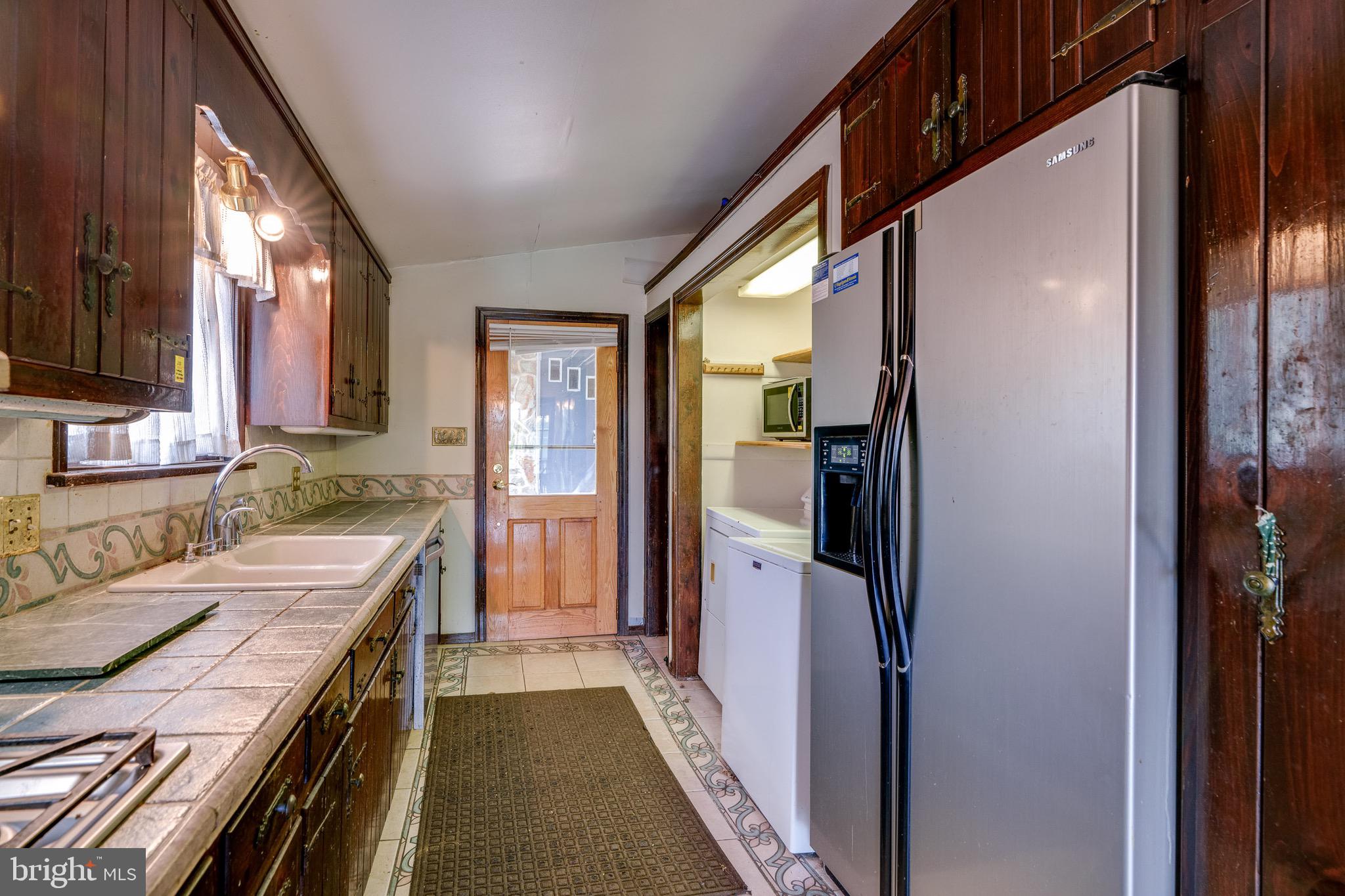 701 Bridge Valley Road Pequea, PA 17565 - Photo 17 of 91 a kitchen with a refrigerator and a sink
