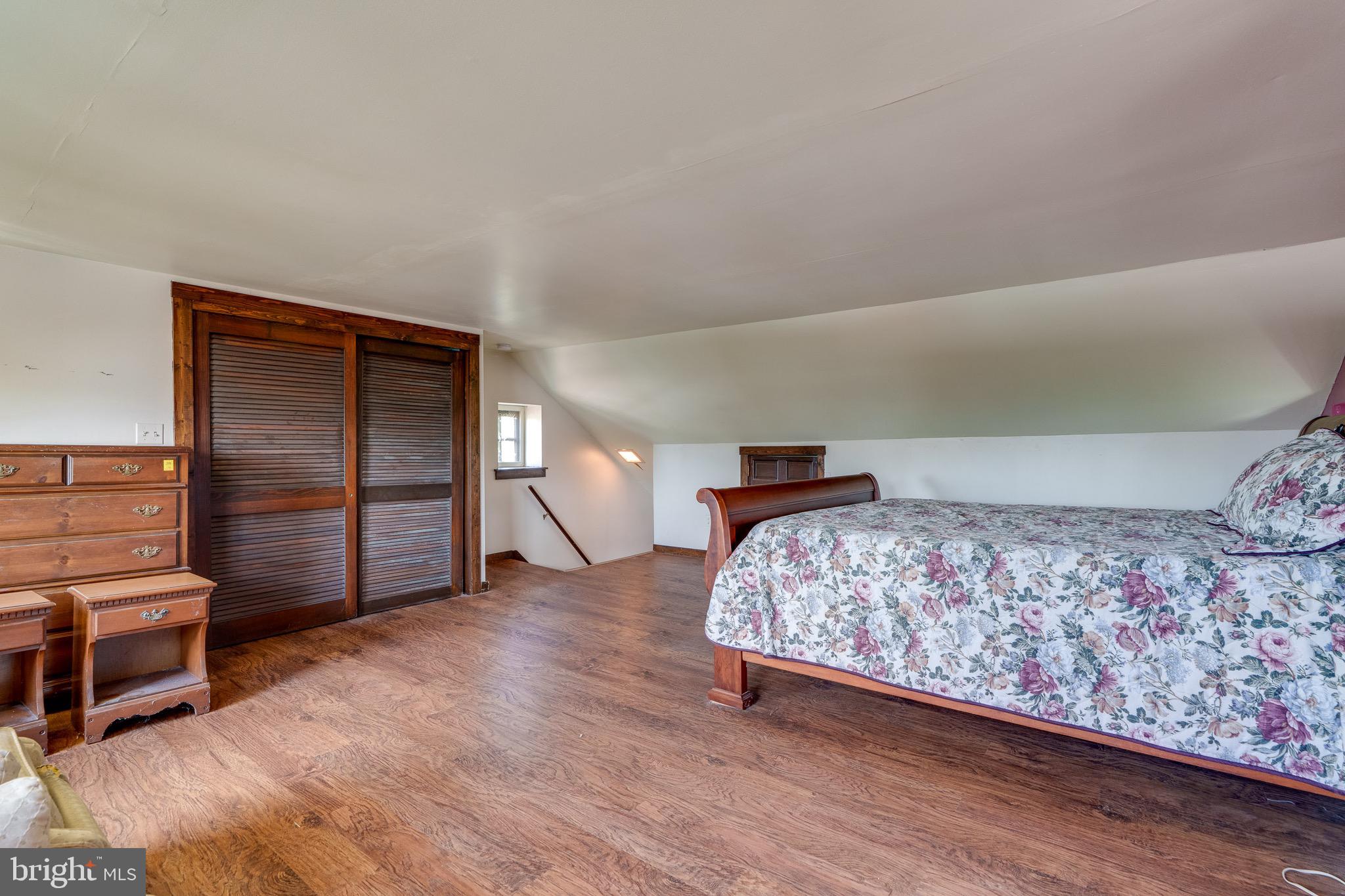 701 Bridge Valley Road Pequea, PA 17565 - Photo 38 of 91 a bedroom with a bed and a lamp on dresser