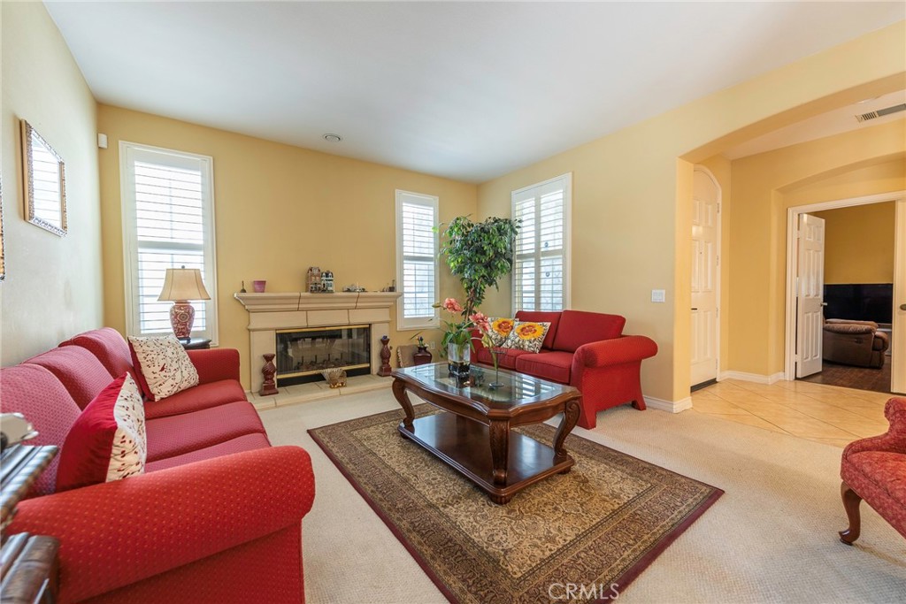 10281 Hillside Road Rancho Cucamonga, CA 91737 - Photo 12 of 60 a living room with furniture a rug and a large window