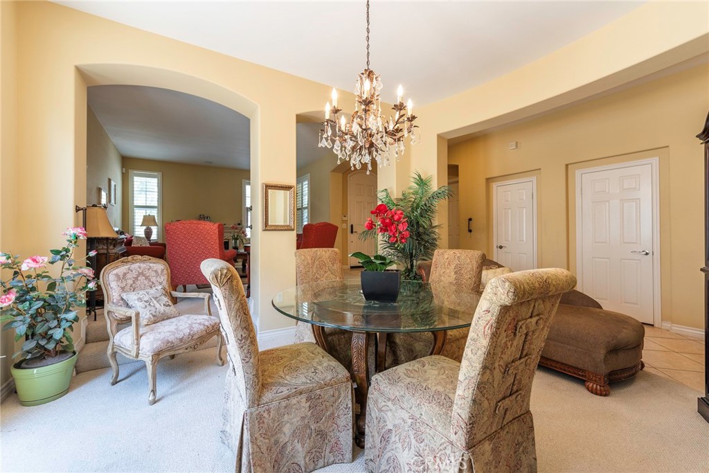 10281 Hillside Road Rancho Cucamonga, CA 91737 - Photo 14 of 60 a view of a dining room with furniture and chandelier