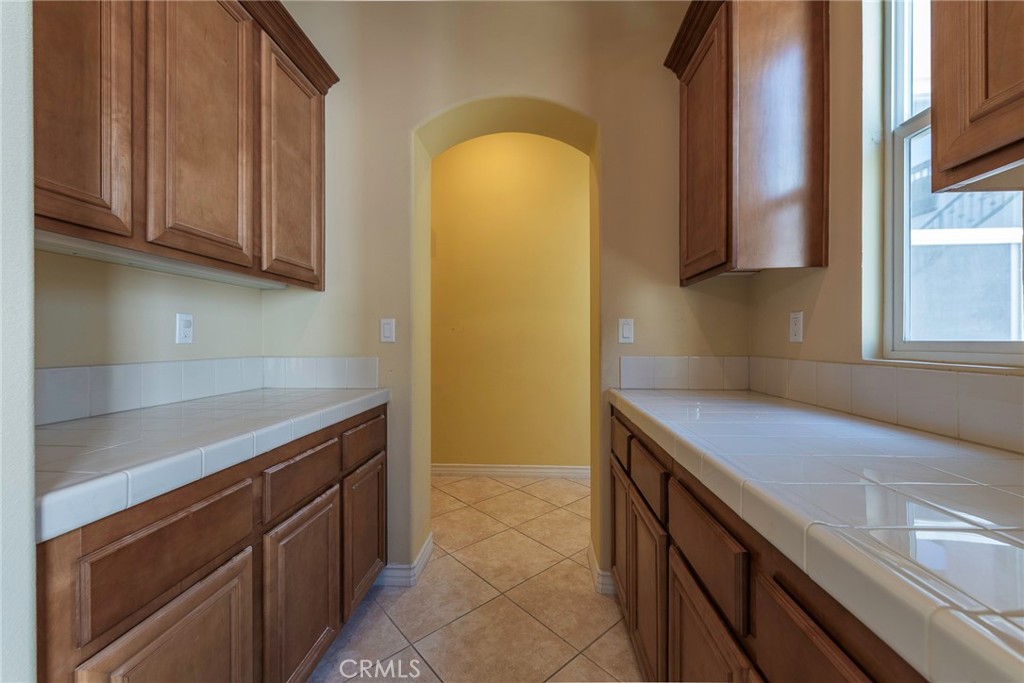 10281 Hillside Road Rancho Cucamonga, CA 91737 - Photo 15 of 60 a kitchen with a sink and a stove